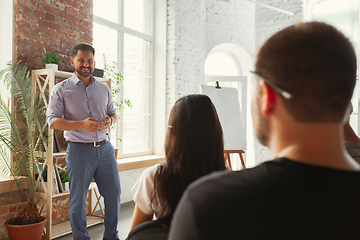 Image showing Male speaker giving presentation in hall at university workshop