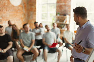 Image showing Male speaker giving presentation in hall at university workshop