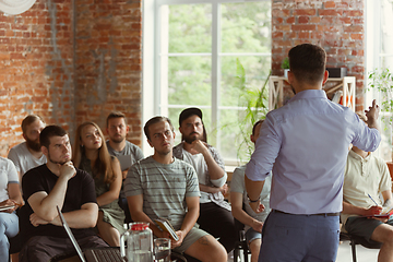 Image showing Male speaker giving presentation in hall at university workshop