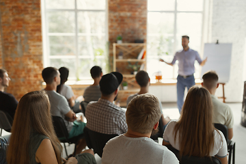 Image showing Male speaker giving presentation in hall at university workshop