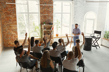 Image showing Male speaker giving presentation in hall at university workshop