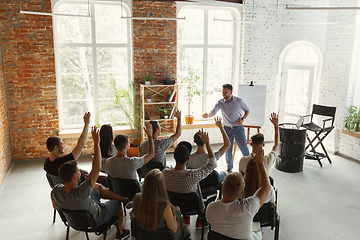 Image showing Male speaker giving presentation in hall at university workshop