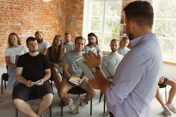 Image showing Male speaker giving presentation in hall at university workshop