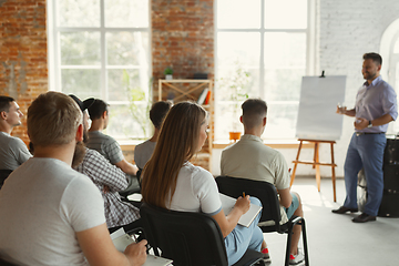 Image showing Male speaker giving presentation in hall at university workshop