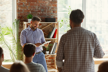 Image showing Male speaker giving presentation in hall at university workshop