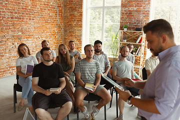 Image showing Male speaker giving presentation in hall at university workshop