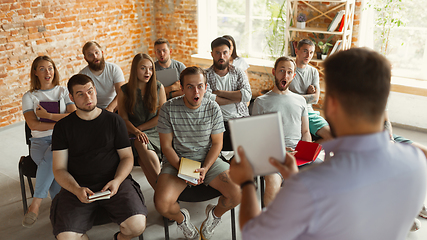 Image showing Male speaker giving presentation in hall at university workshop