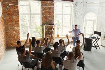 Image showing Male speaker giving presentation in hall at university workshop