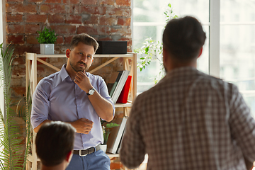 Image showing Male speaker giving presentation in hall at university workshop