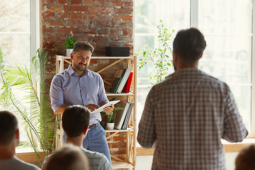 Image showing Male speaker giving presentation in hall at university workshop