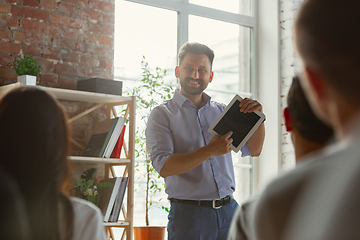 Image showing Male speaker giving presentation in hall at university workshop