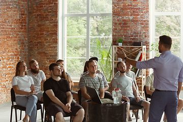 Image showing Male speaker giving presentation in hall at university workshop