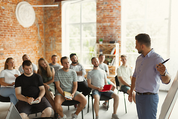 Image showing Male speaker giving presentation in hall at university workshop