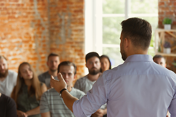 Image showing Male speaker giving presentation in hall at university workshop