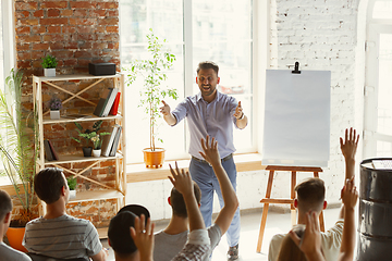 Image showing Male speaker giving presentation in hall at university workshop