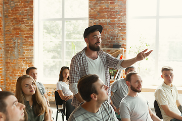 Image showing Male speaker giving presentation in hall at university workshop