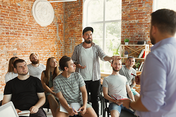 Image showing Male speaker giving presentation in hall at university workshop