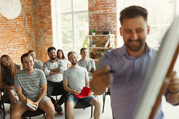 Image showing Male speaker giving presentation in hall at university workshop