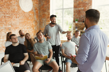 Image showing Male speaker giving presentation in hall at university workshop