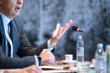 Image showing close up of business people taking notes