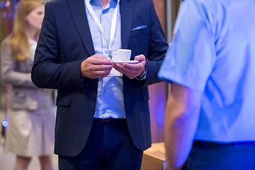 Image showing closeup of businessman holding a cup of coffee