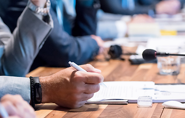 Image showing close up of business people taking notes