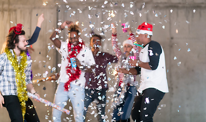 Image showing multiethnic group of casual business people having confetti part