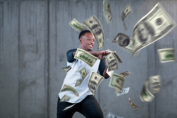 Image showing black businessman making the rain of money