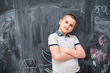 Image showing portrait of little boy in front of chalkboard