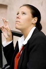 Image showing businesswoman with cigarette