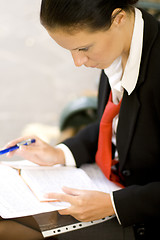 Image showing businesswoman is writing note