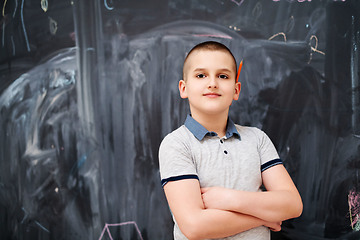 Image showing portrait of little boy in front of chalkboard