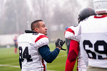 Image showing confident American football players leaving the field