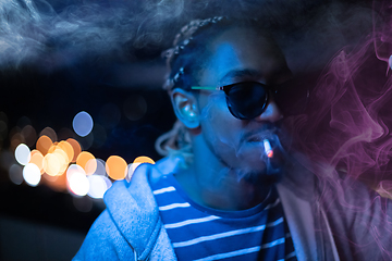 Image showing african american man smiking cigarette  at nigth