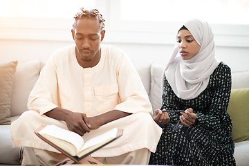 Image showing african couple at home reading quaran