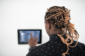 Image showing African man using smart home screen