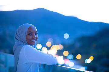 Image showing African  modern Muslim woman in night at balcony