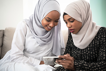 Image showing afro girls looking at phone