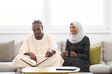 Image showing african couple at home reading quaran