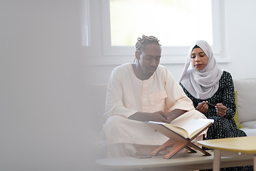 Image showing african couple at home reading quaran
