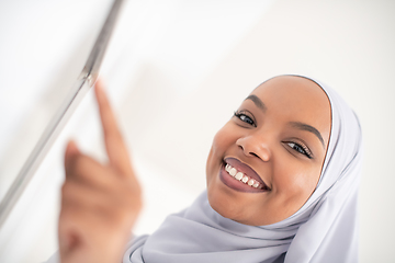 Image showing african woman using smart home screen