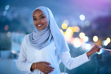 Image showing African  modern Muslim woman in night at balcony