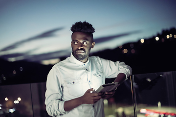 Image showing Young  Afro man on  street at night using phone