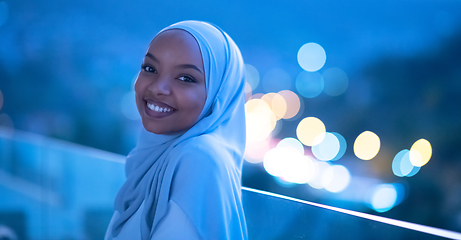 Image showing African  modern Muslim woman in night at balcony