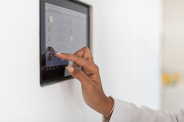 Image showing close up african woman using smart home screen