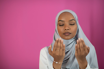 Image showing African Muslim woman makes traditional prayer to God