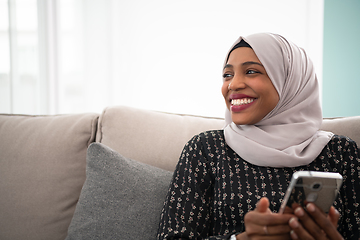 Image showing african  woman using smartphone at home