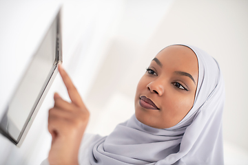 Image showing african woman using smart home screen