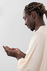 Image showing african man pray to Allah