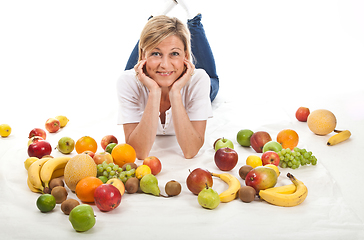 Image showing Fruits and blond cute woman lying